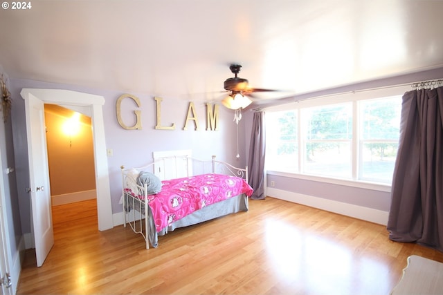 bedroom with ceiling fan and light hardwood / wood-style floors