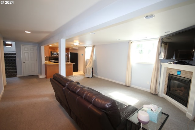 living room with a healthy amount of sunlight and light colored carpet