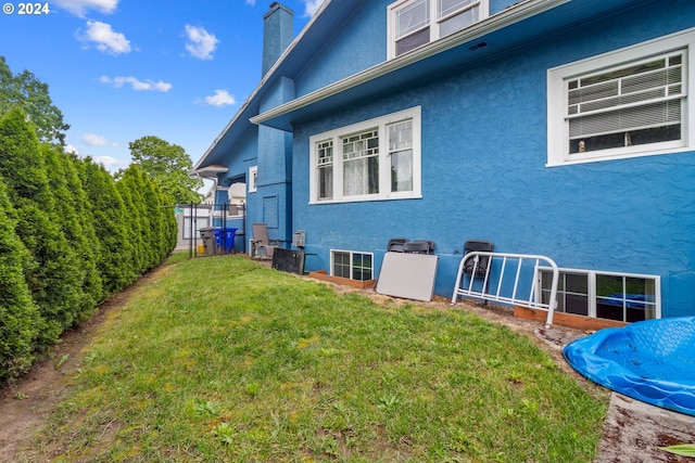 view of side of home with a lawn