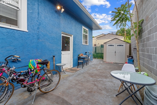 view of patio / terrace featuring a storage unit