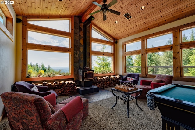 156 Peppermill Rd, Kelso, WA 98626 - living area with a wood stove, ceiling fan, high vaulted ceiling, wood ceiling with exposed beams, and stone tile flooring
