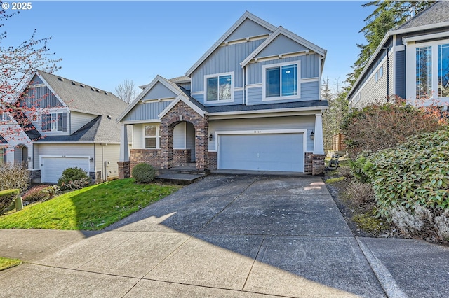 craftsman inspired home with an attached garage, board and batten siding, and driveway