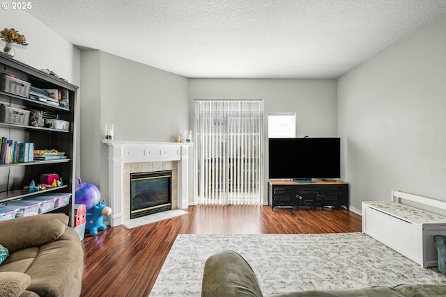 17364 SW Novato Ln, Beaverton, OR 97078 - living area featuring wood finished floors, a tile fireplace, and a textured ceiling