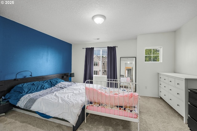 17364 SW Novato Ln, Beaverton, OR 97078 - bedroom featuring multiple windows, a textured ceiling, and light carpet
