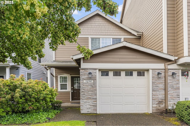 9234 SW Cascara Ln, Tualatin, OR 97062 - view of front of property with stone siding, a garage, and asphalt driveway