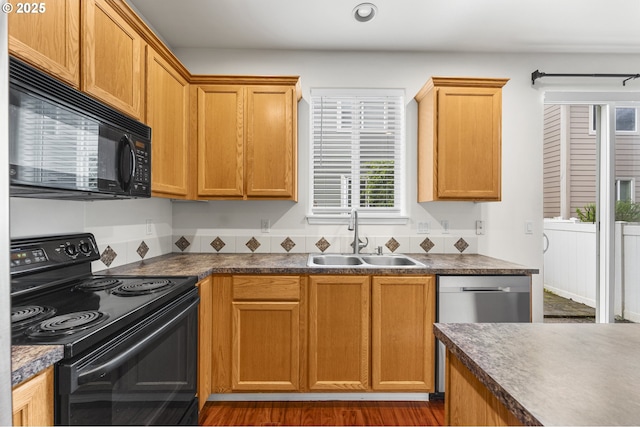 9234 SW Cascara Ln, Tualatin, OR 97062 - kitchen featuring black appliances, a sink, dark countertops, and recessed lighting