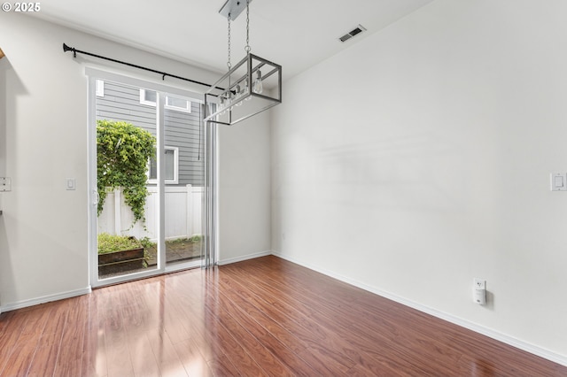 9234 SW Cascara Ln, Tualatin, OR 97062 - unfurnished dining area with wood finished floors, baseboards, and a chandelier