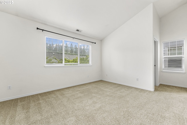 9234 SW Cascara Ln, Tualatin, OR 97062 - empty room featuring carpet floors, vaulted ceiling, and baseboards