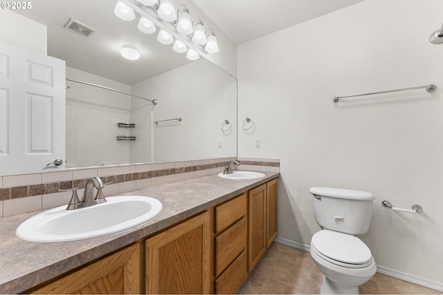 9234 SW Cascara Ln, Tualatin, OR 97062 - full bathroom with toilet, baseboards, tile patterned flooring, double vanity, and a shower