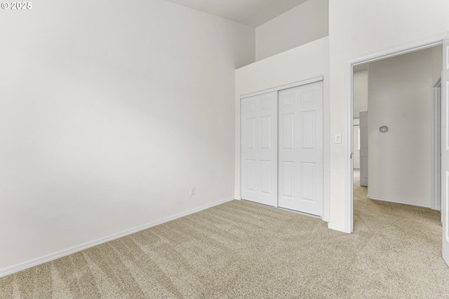 9234 SW Cascara Ln, Tualatin, OR 97062 - unfurnished bedroom with carpet flooring, a closet, baseboards, and a towering ceiling