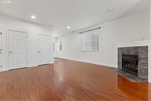 9234 SW Cascara Ln, Tualatin, OR 97062 - unfurnished living room featuring wood finished floors, a tile fireplace, recessed lighting, and baseboards