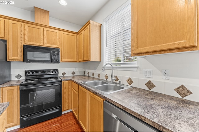 9234 SW Cascara Ln, Tualatin, OR 97062 - kitchen featuring black appliances, a sink, and wood finished floors
