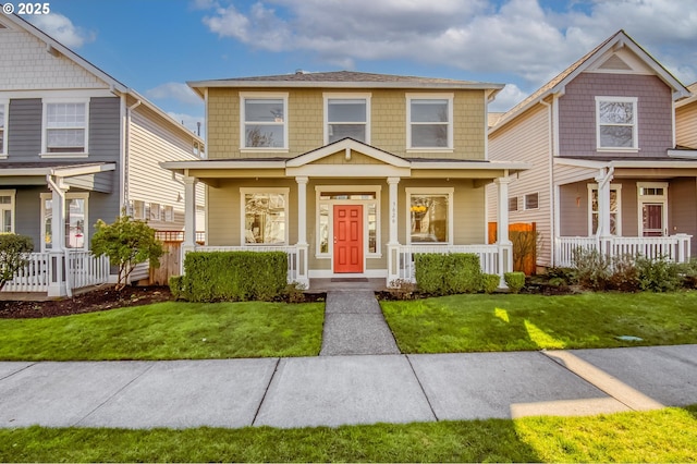 traditional style home featuring a porch and a front yard