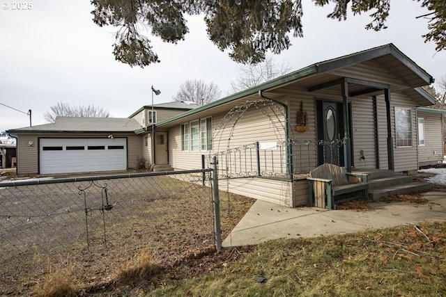 view of front of home featuring fence, driveway, and an attached garage