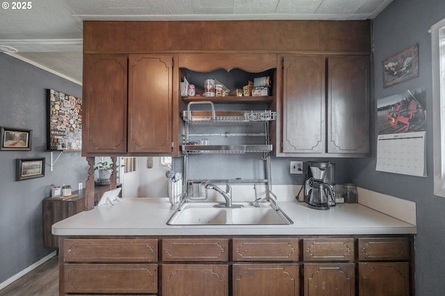 2440 Porter St, Lebanon, OR 97355 - kitchen featuring a sink, light countertops, open shelves, and wood finished floors