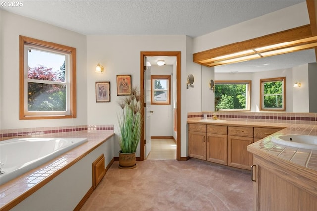 601 NW 110th Way, Vancouver, WA 98685 - full bath with vanity, a bath, and a textured ceiling