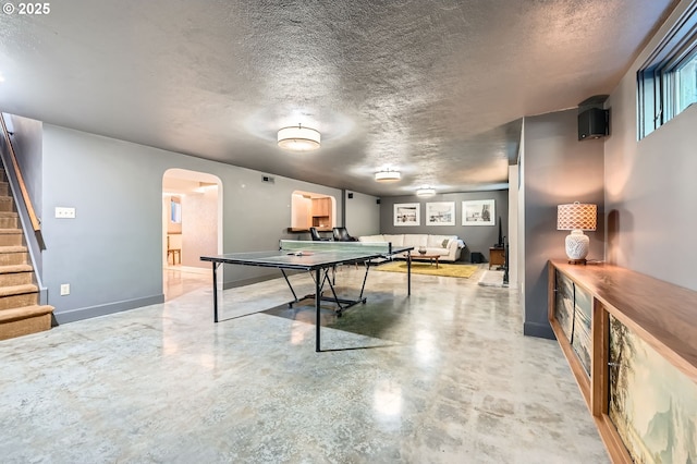 1834 SE 20th Ave, Portland, OR 97214 - game room featuring arched walkways, a textured ceiling, and concrete flooring