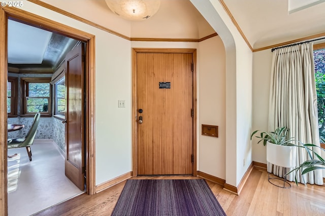 1834 SE 20th Ave, Portland, OR 97214 - foyer entrance featuring arched walkways, light wood finished floors, and ornamental molding