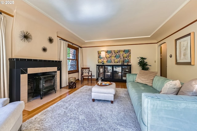1834 SE 20th Ave, Portland, OR 97214 - living room with wood finished floors, a wood stove, arched walkways, and crown molding
