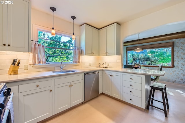 1834 SE 20th Ave, Portland, OR 97214 - kitchen featuring appliances with stainless steel finishes, white cabinets, tasteful backsplash, healthy amount of natural light, and wallpapered walls
