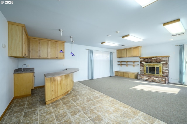 1736 NE Hembree St, Mcminnville, OR 97128 - kitchen with baseboards, light brown cabinetry, carpet, and a sink