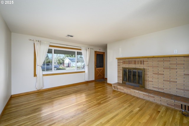 1736 NE Hembree St, Mcminnville, OR 97128 - unfurnished living room with wood finished floors, a brick fireplace, and baseboards