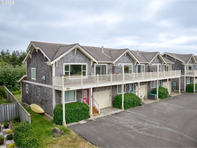 315 5th St NW Unit 101, Long Beach, WA 98631 - view of property with a garage, driveway, a balcony, and roof with shingles
