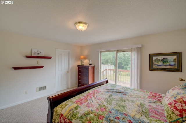315 5th St NW Unit 101, Long Beach, WA 98631 - bedroom with access to exterior, carpet flooring, and a textured ceiling
