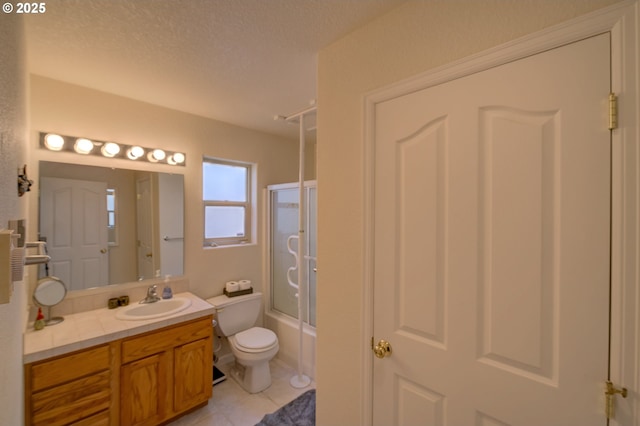 315 5th St NW Unit 101, Long Beach, WA 98631 - bathroom featuring vanity, bath / shower combo with glass door, tile patterned floors, and a textured ceiling