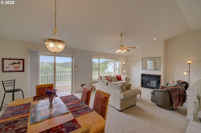 315 5th St NW Unit 101, Long Beach, WA 98631 - dining space featuring a glass covered fireplace, vaulted ceiling, ceiling fan, and light colored carpet