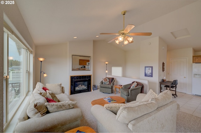 315 5th St NW Unit 101, Long Beach, WA 98631 - living area with vaulted ceiling, a ceiling fan, a tile fireplace, and light tile patterned floors