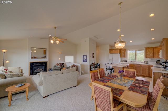315 5th St NW Unit 101, Long Beach, WA 98631 - dining room featuring vaulted ceiling, light carpet, recessed lighting, a tile fireplace, and a ceiling fan