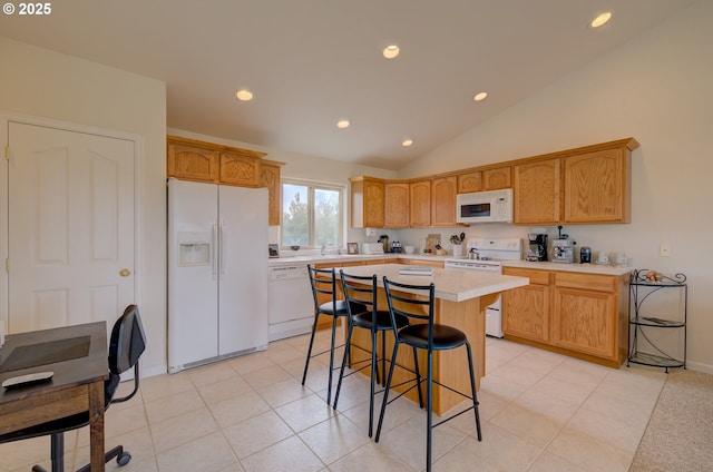 315 5th St NW Unit 101, Long Beach, WA 98631 - kitchen with white appliances, light countertops, recessed lighting, a kitchen breakfast bar, and lofted ceiling