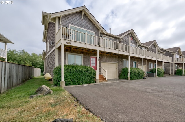 315 5th St NW Unit 101, Long Beach, WA 98631 - view of property with a balcony, asphalt driveway, and a garage