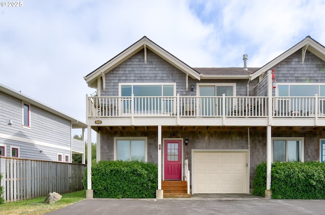 315 5th St NW Unit 101, Long Beach, WA 98631 - multi unit property featuring a garage, asphalt driveway, and a balcony