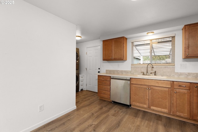 kitchen featuring sink, dishwasher, and hardwood / wood-style flooring