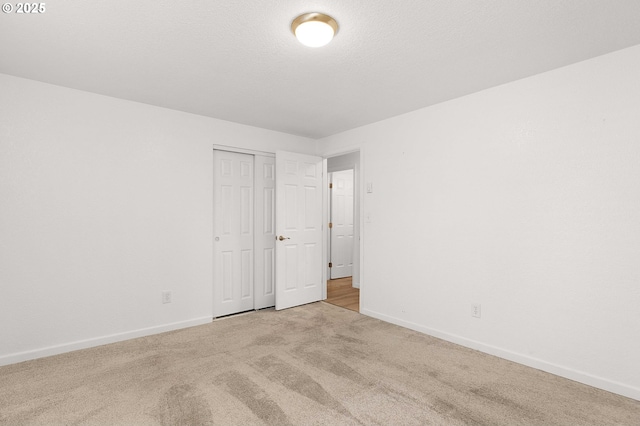 spare room featuring light colored carpet