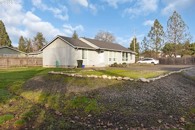 back of property featuring a lawn