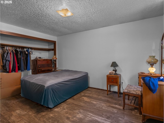 bedroom featuring a textured ceiling and wood finished floors