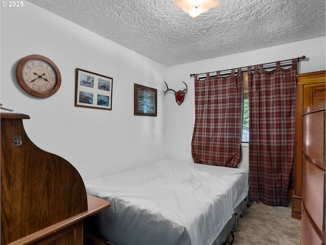 carpeted bedroom featuring a textured ceiling