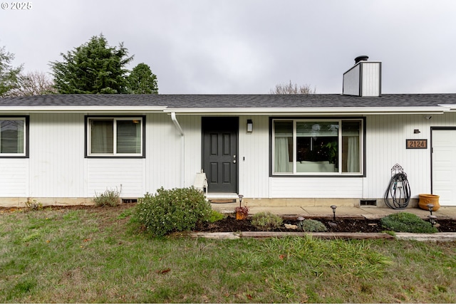 single story home with a garage and a front lawn