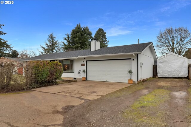 ranch-style house featuring a garage and a front yard