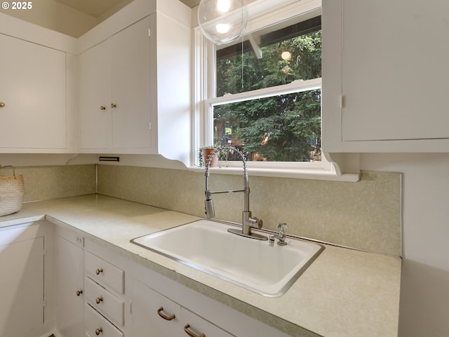 1630 SE 46th Ave, Portland, OR 97215 - kitchen featuring white cabinetry, light countertops, and tasteful backsplash