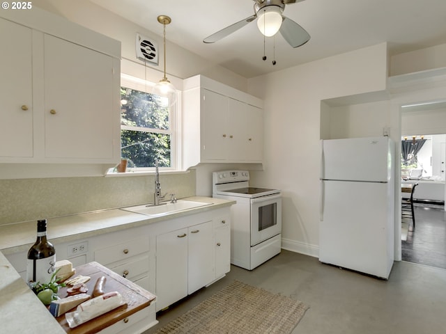 1630 SE 46th Ave, Portland, OR 97215 - kitchen featuring white appliances, finished concrete flooring, light countertops, white cabinetry, and pendant lighting