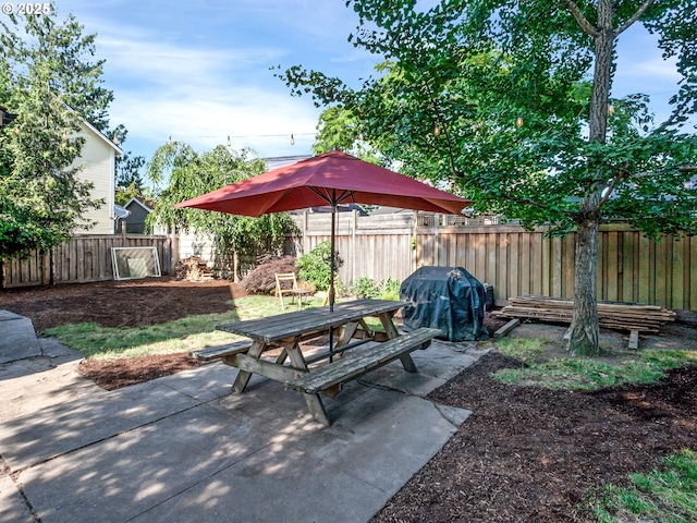 1630 SE 46th Ave, Portland, OR 97215 - fenced backyard with outdoor dining space, a patio, and a grill