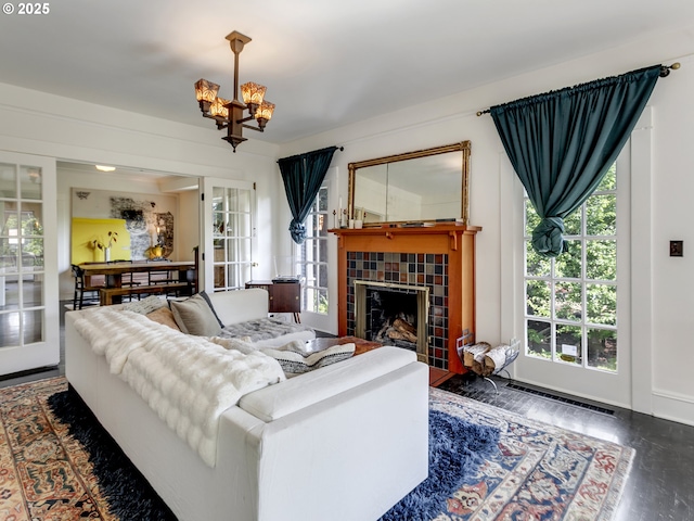 1630 SE 46th Ave, Portland, OR 97215 - living room featuring a chandelier, french doors, wood finished floors, and a fireplace