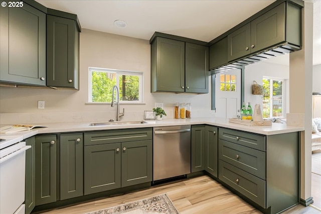 2251 SE 139th Ave, Portland, OR 97233 - kitchen with stainless steel dishwasher, green cabinets, light countertops, light wood finished floors, and range