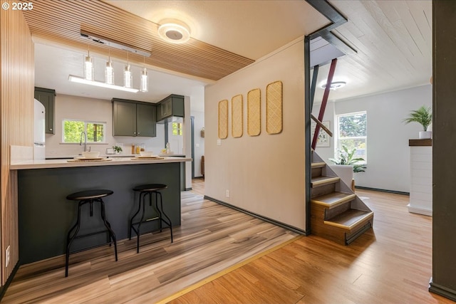 2251 SE 139th Ave, Portland, OR 97233 - kitchen featuring light wood finished floors, a kitchen breakfast bar, and healthy amount of natural light