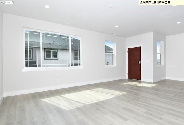 unfurnished room with light wood-type flooring