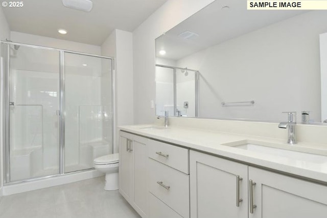 bathroom with tile patterned flooring, vanity, toilet, and walk in shower